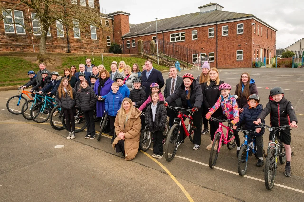 A group of people with children on bikes