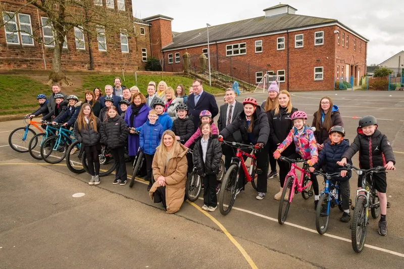 A group of people with children on bikes